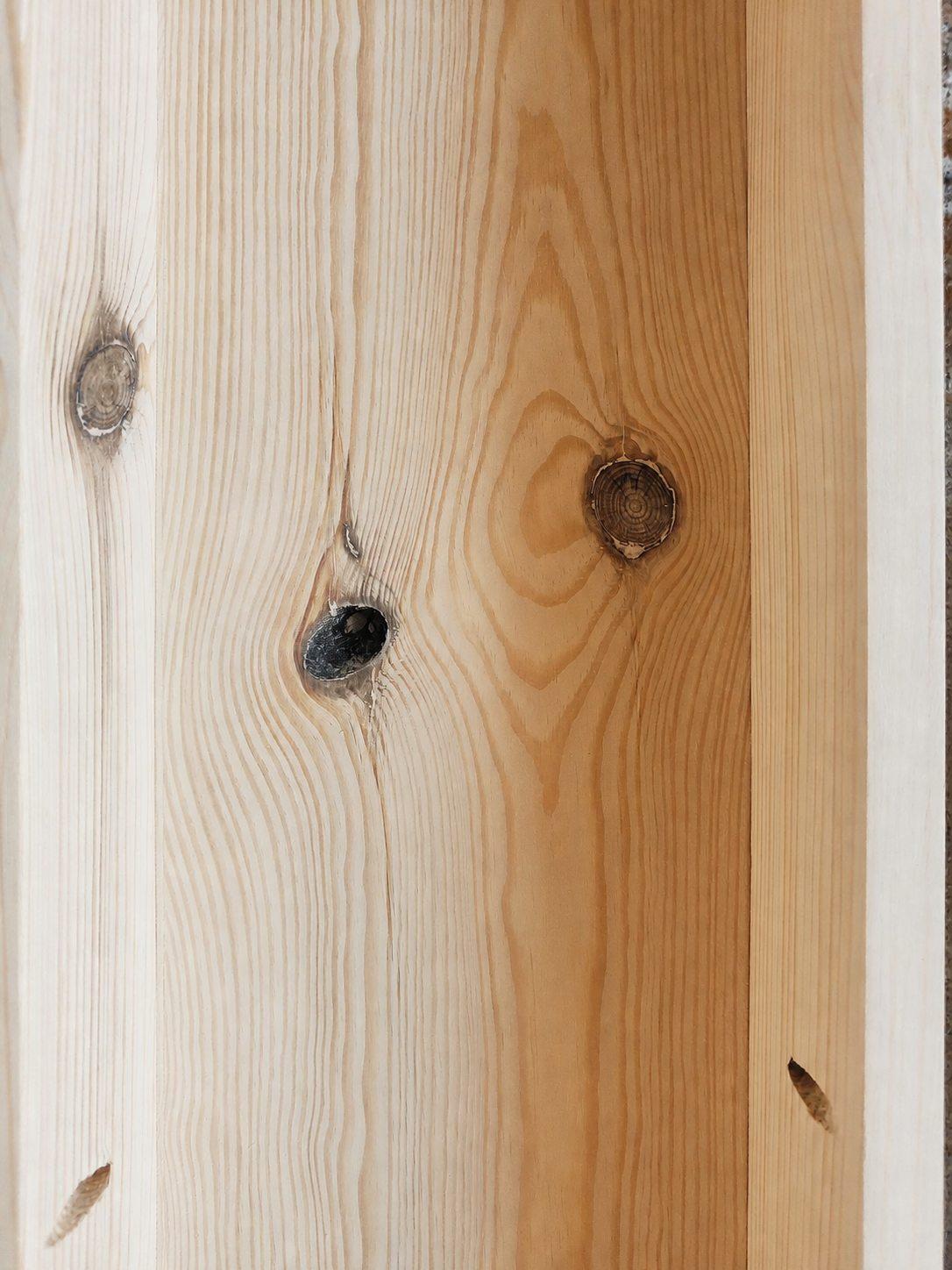 New solid pine boards with natural knots on a concealed furniture surface during workshop preparation