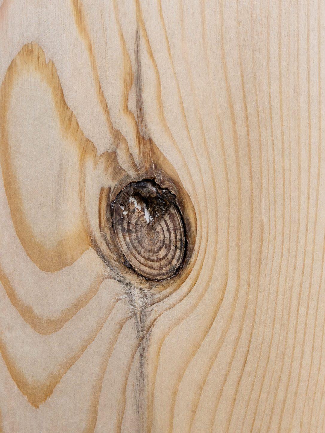 Close view of a natural knot in a newly prepared solid pine board