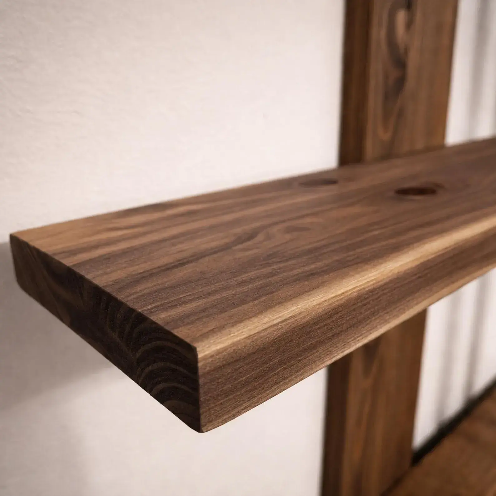 Solid walnut shelf surface showing natural knots and grain variation