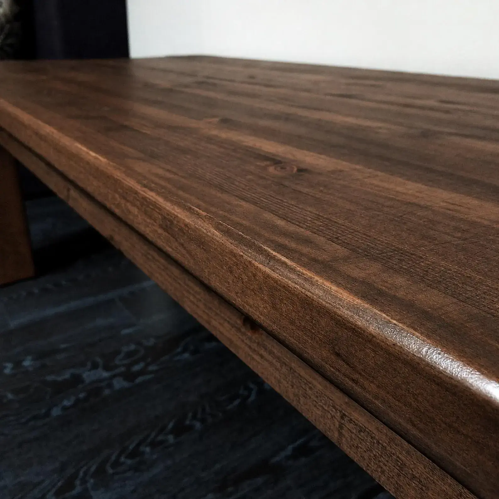 Thick solid walnut tabletop with rich brown grain and hand-finished edge