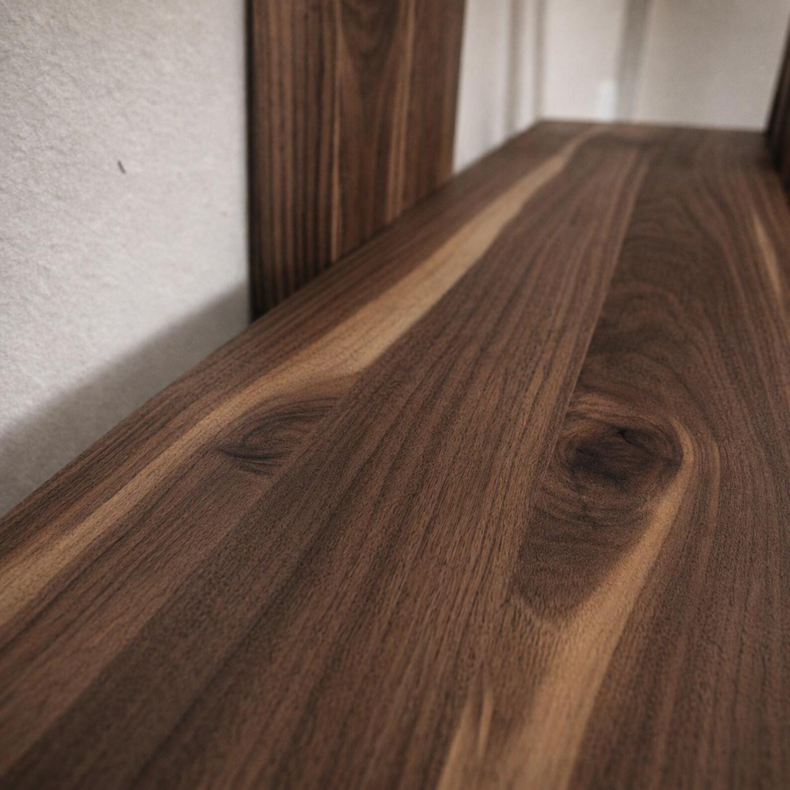 Close-up of natural walnut grain on the hand-finished shelf