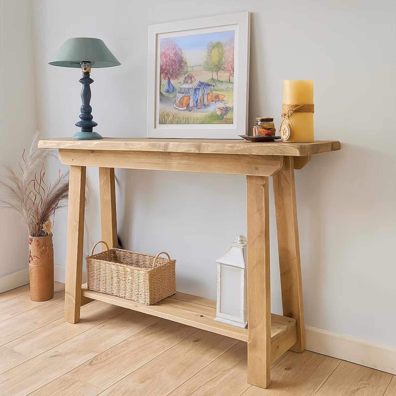 Rustic pine console table with lower shelf styled in a farmhouse hallway